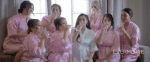 Cute photo and video op for the bridesmaids when getting ready on the wedding day: cute robes and a toast to marriage! | www.EvermooreFilms.com